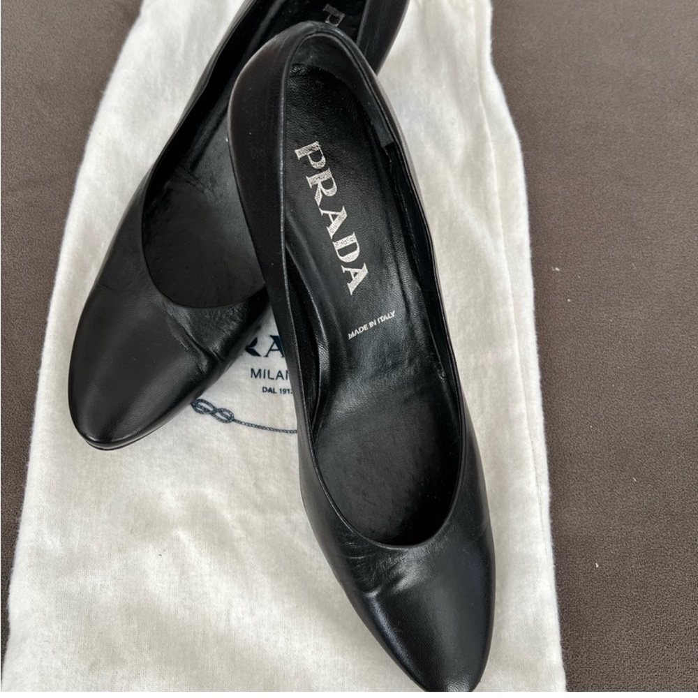 Prada black leather pumps. Size 5.5. Very gently worn. 
Come with duster.